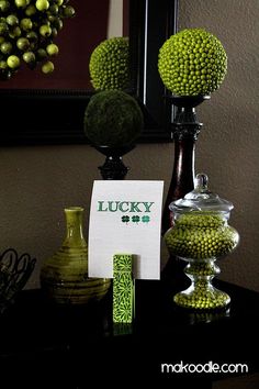 there are some green candies on the table next to a sign that says lucky