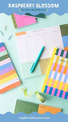 the raspberry blossom planner is on top of a desk with pens and sticky notes