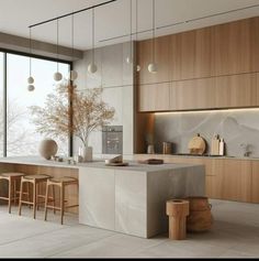 a modern kitchen with marble counter tops and wooden cabinets, along with stools in front of the window