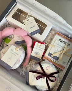 an open gift box filled with baby items