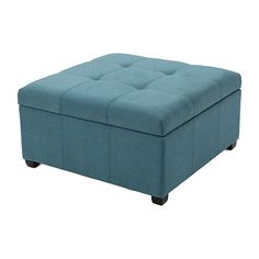 a blue ottoman that is sitting on the floor