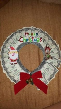 a christmas wreath made out of dollar bills