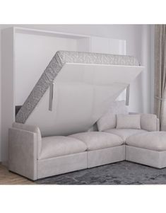 a white couch with a pull out bed in the middle of it's living room