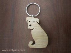 a wooden keychain with a dog on it