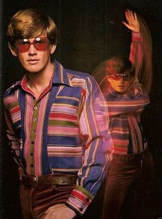 two men in striped shirts and red sunglasses posing for a photo with their hands up