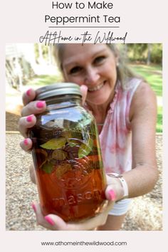 a woman holding a jar full of homemade peppermint tea with text overlay that reads how to make peppermint tea at home on the weekend