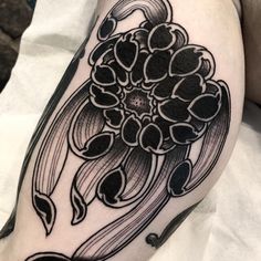 a black and white flower tattoo on the arm