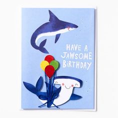 a birthday card with an image of a shark holding balloons