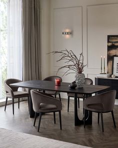 a dining room table with chairs around it