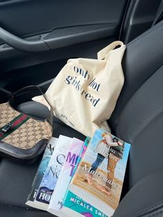 a bag and some books in the back seat of a car