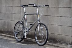 a bike leaning against a wall on the street