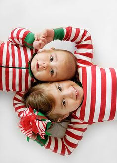 three children in striped pajamas laying on top of each other