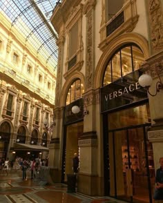 the inside of a shopping mall with people walking around