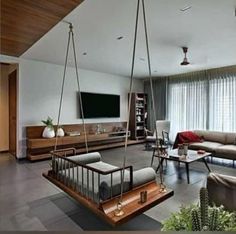 a living room filled with furniture and a flat screen tv mounted to the side of a wall