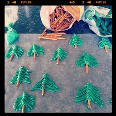 green christmas tree shaped cookies sitting on top of a cookie sheet