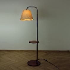 a floor lamp with a light shade on it