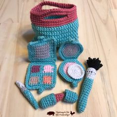 a crocheted bag and other items sitting on a table