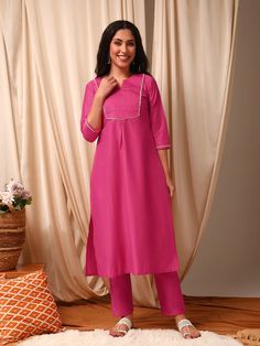 This Pink Women Pleated Gotta Patti Pure Silk Kurta with Trousers is perfect for those looking for a stylish and comfortable outfit. The kurta features a solid self design with a pleated style and round neck, while the trousers have a partially elasticated waistband for a perfect fit. Made from pure silk, this set is s Western Kurtis, Gotta Patti, Comfortable Outfit, Silk Kurta, Eid Collection, Self Design, Comfortable Outfits, Three Quarter Sleeves, Flared Sleeves