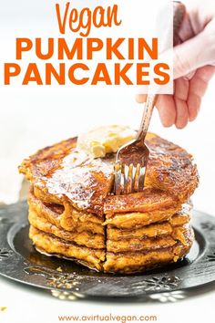 a stack of pancakes with butter and syrup being eaten by a person holding a fork