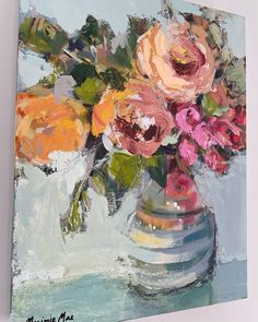 a painting of pink and orange flowers in a silver vase on a blue background with white lettering