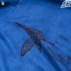 a blue t - shirt with an image of a bird on it