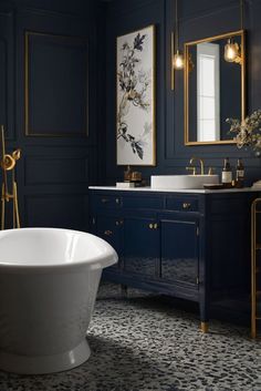 a white bath tub sitting next to a sink in a bathroom under a painting on the wall