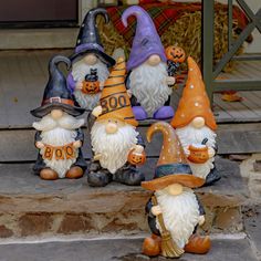 seven garden gnomes sitting on the steps