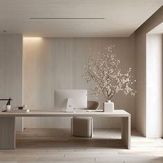 a white desk sitting in the middle of a room next to a vase filled with flowers