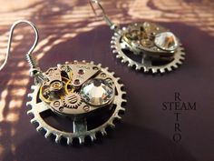 "Elegant Steampunkery! Vintage 17 jewel Watch mechanisms on a fixed gearwheel, featuring 2 stunning clear Swarovski Crystals. The findings are 925 Sterling silver. Lightweight, perfect for adding a touch of class to that steampunk, cosplay outfit, but understated enough to be used for everyday use! the choice is yours! Steamretro has a 100% feedback rating! When you buy from Steamretro you will receive a fantastic Handmade piece of jewelry, quite distinct from any other boutique! We offer FREE s Punk Style Round Earrings As Gift, Silver Steampunk Earrings, Steampunk Nickel-free Earrings As Gift, Steampunk Nickel-free Earrings For Gift, Steampunk Metal Earrings For Gift, Steampunk Style Earrings As Gift, Watch Mechanism, Steampunk Watch, Earrings Gothic