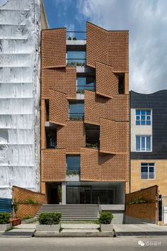 the building is made out of bricks and has stairs leading up to it