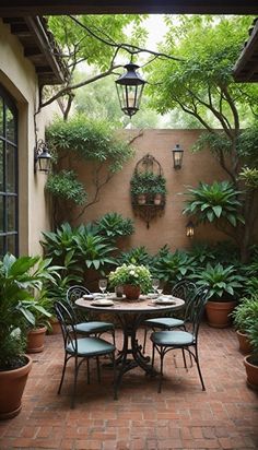 an outdoor dining area with potted plants and hanging lights