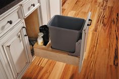 a trash can sitting on top of a wooden shelf in the middle of a kitchen