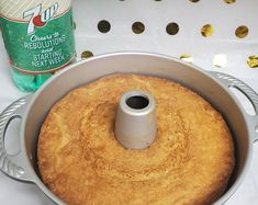 a cake in a pan next to a bottle of tea