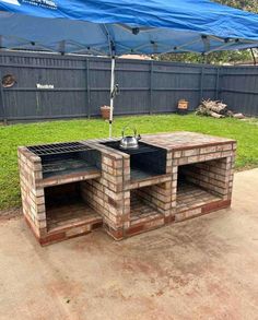 an outdoor grill made out of bricks in the backyard