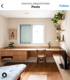 a bedroom with a bed, desk and television in it's corner area next to a window