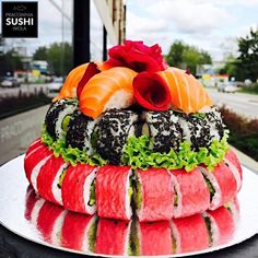 sushi platter with various types of sushi arranged on the top and bottom