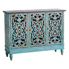 an old blue cabinet with ornate carvings on the doors and drawers, painted in teal