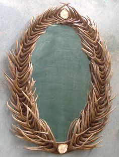 a circular mirror made out of antler stalks