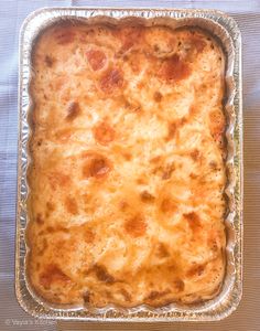 a casserole dish with cheese and meat in it on top of a table