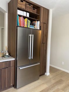 a stainless steel refrigerator freezer sitting inside of a kitchen