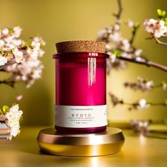 a pink candle sitting on top of a wooden table