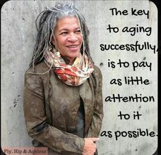 a woman with dreadlocks standing in front of a wall and saying the key to aging successfully is to pay as little attention to it as possible