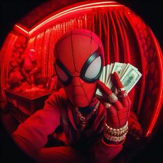 a person in a spiderman mask holding money