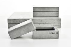 three cement boxes with the word gravalli written on them and one is empty