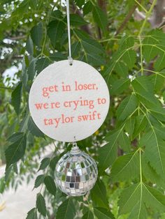 an ornament hanging from a tree that says get in closer, we're crying to taylor swift