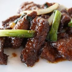 some meat and vegetables on a white plate