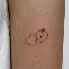 two hearts tattoo on the left arm