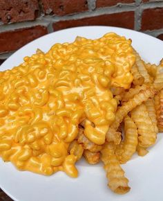 a white plate topped with cheesy macaroni and cheese