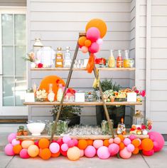 an outdoor bar set up with balloons and confetti