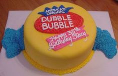 a yellow cake with red and blue frosting on it's side that says bubble bubble